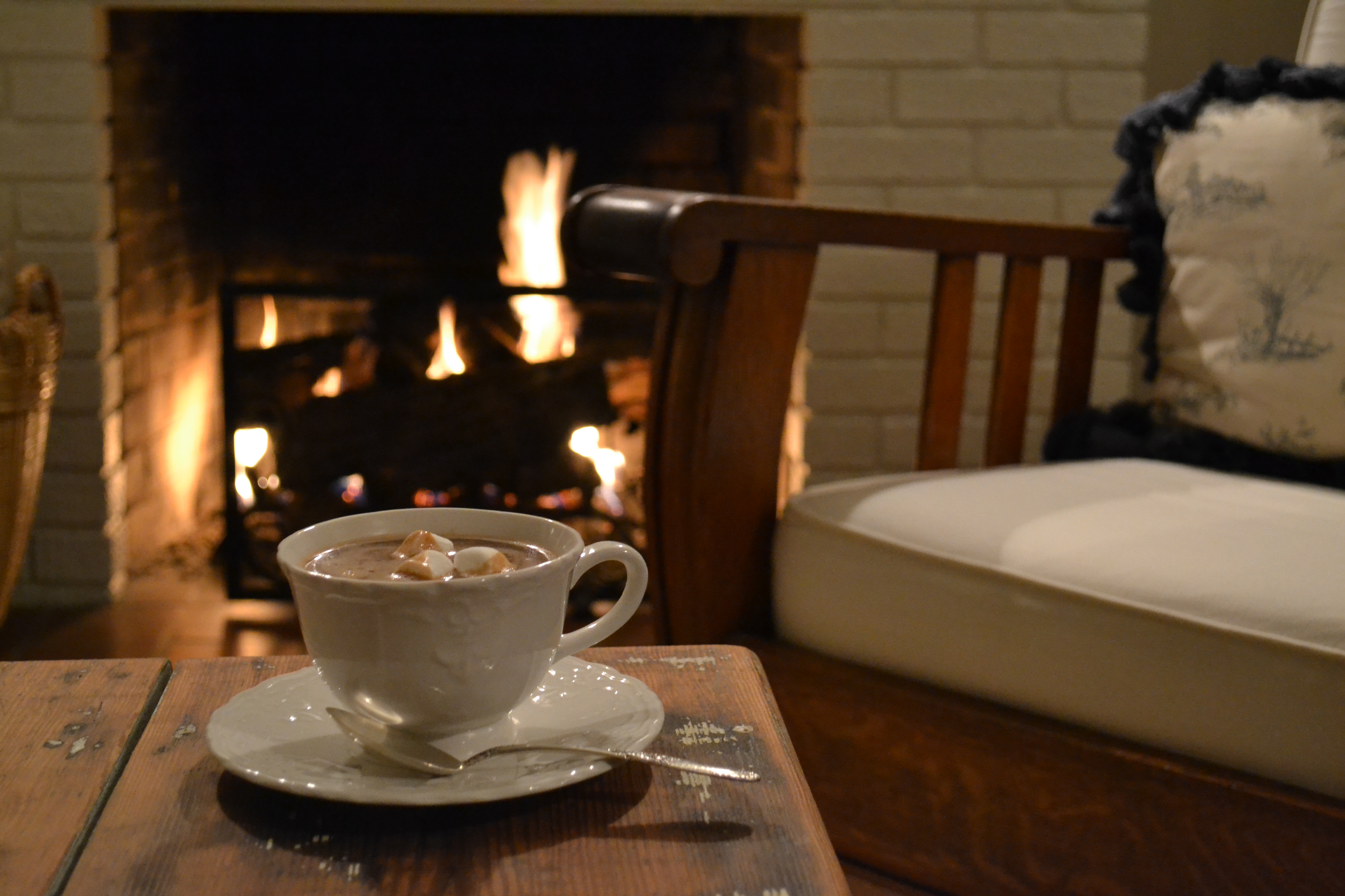 enjoying hot chocolate by the fire