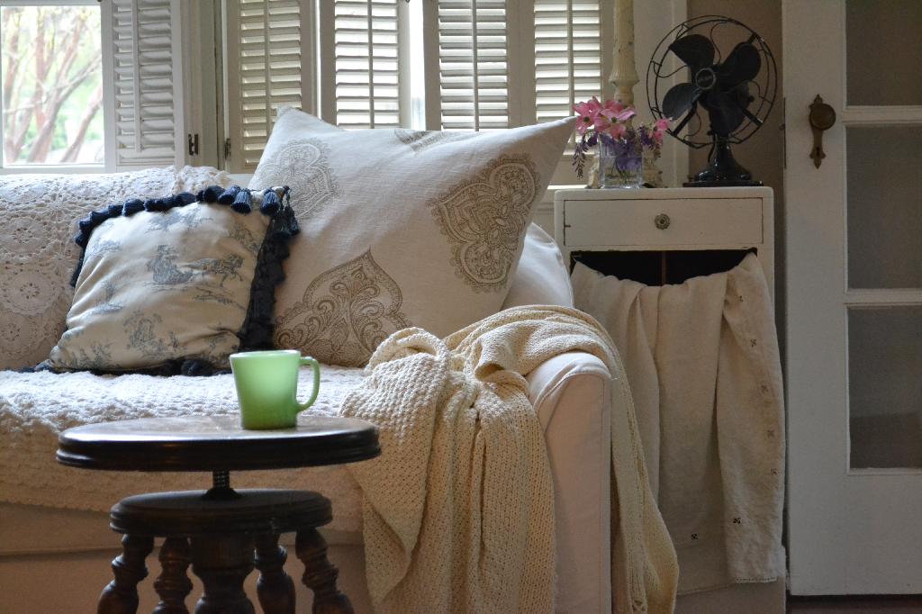taupe cottage living room with a vintage fan