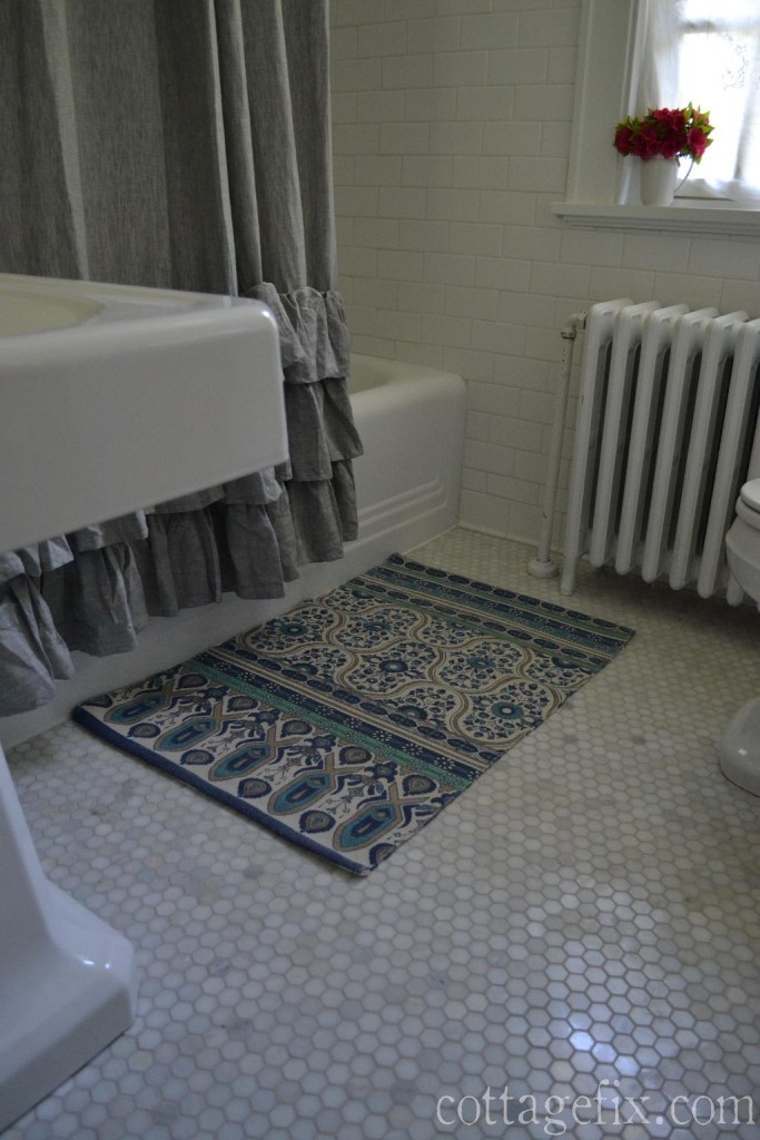 Cottage Fix blog - cottage style bathroom remodel with marble hex floor tiles, classic subway wall tiles, a crystal chandelier , and vintage accessories