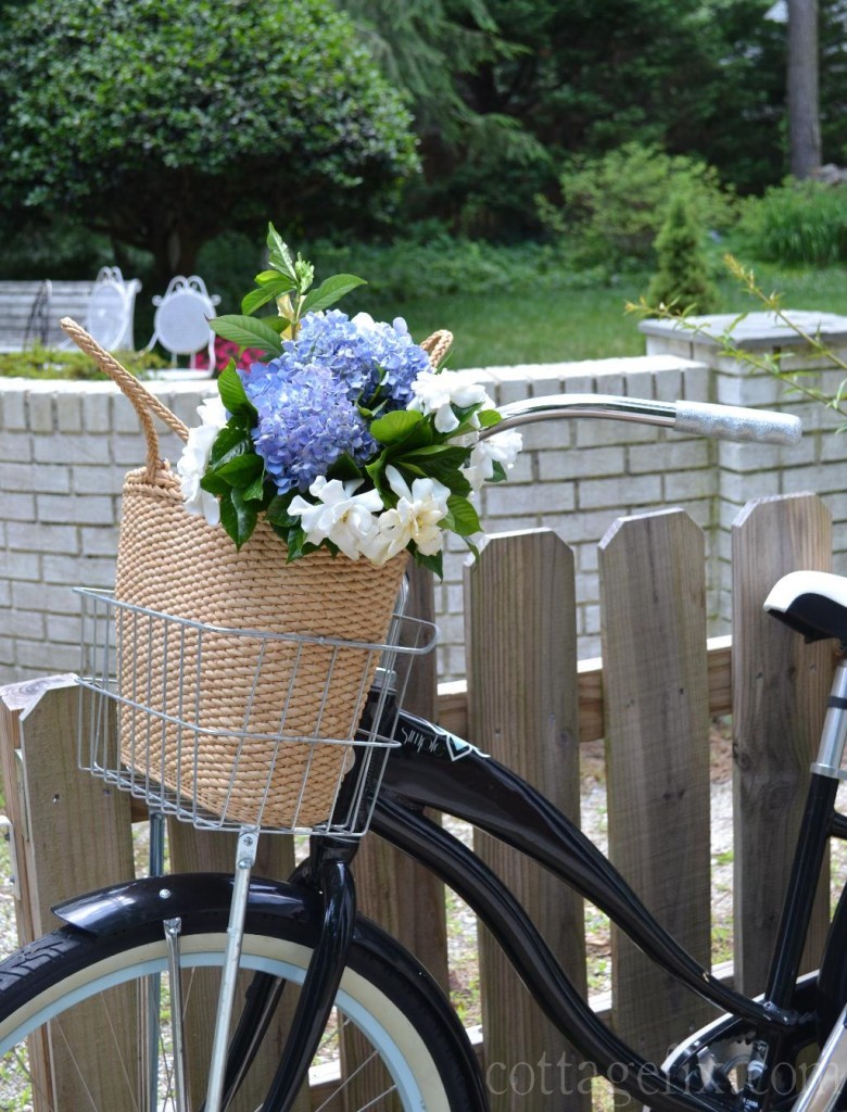 Cottage Fix blog - beach basket with flowers and a bike