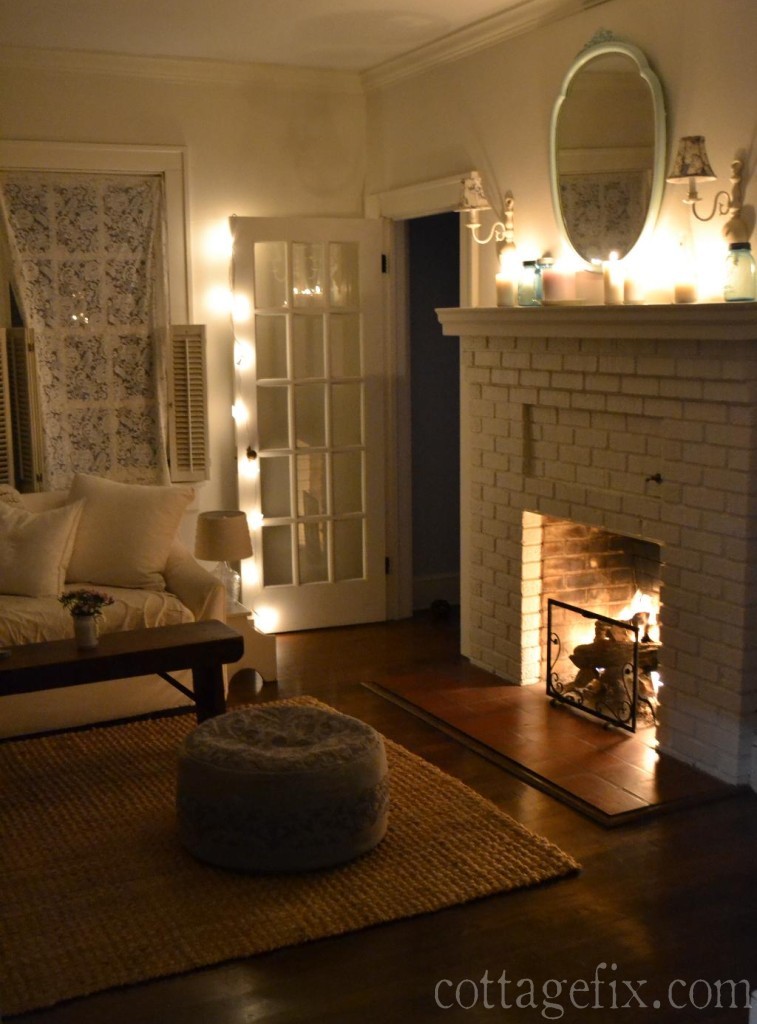 Cottage Fix blog - living room with white candles, twinkle lights, and a cozy fire